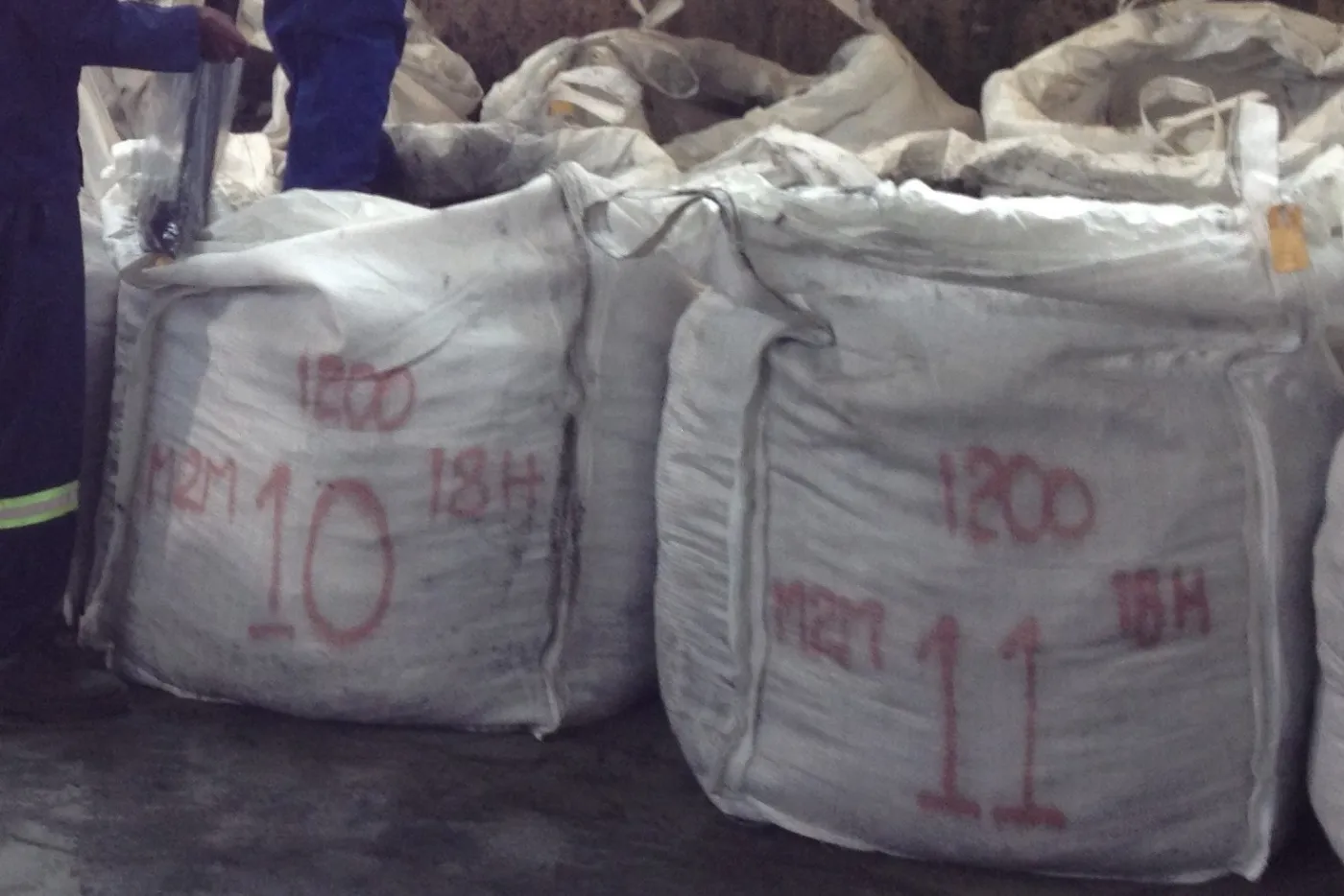 Bulk bags of dark material marked M2M and numbered in red