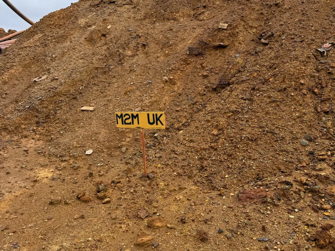 A stockpile with a Mine2Market marker board